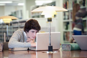 Young man studying in library