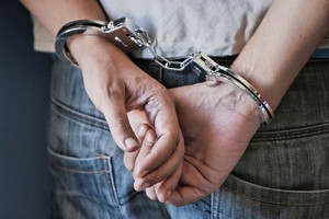 Young man in handcuffs