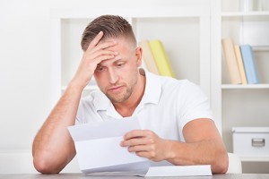 Man reacting in shock to a letter