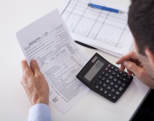 Man crunching numbers on a calculator