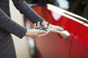Woman with car key in hand