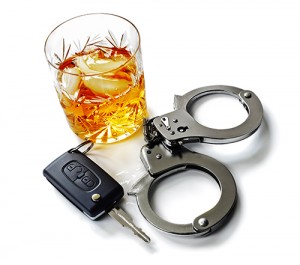 Whiskey with car keys and handcuffs concept for drinking and driving