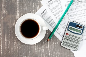Coffee cup and tax forms