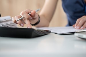 Close up of female accountant making calculations