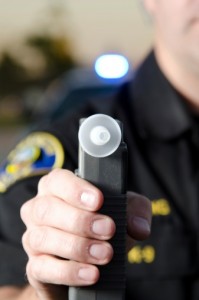 Police officer giving a breathalyzer test