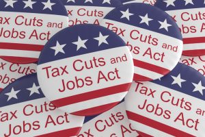 Pile of Tax Cuts And Jobs Act Buttons With US Flag